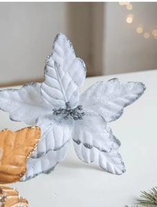 Close-up of white artificial poinsettia with silver glitter edges for Christmas tree decor