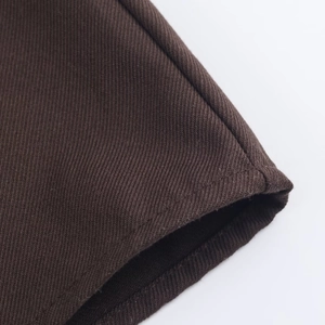 Detailed macro view of the brown twill fabric texture and high-quality stitching detail