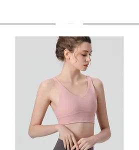 Detailed view of pink sports bra with V-neck and wide straps for high impact fitness