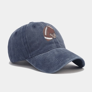 Washed navy blue baseball cap with football and leopard heart print in a 45-degree view