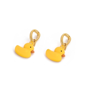Macro detail of cute yellow 3D duck charms with polished golden metal hooks