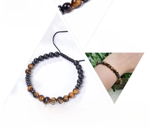 Detail view of Morse code bracelet with tiger eye stones and adjustable black cord