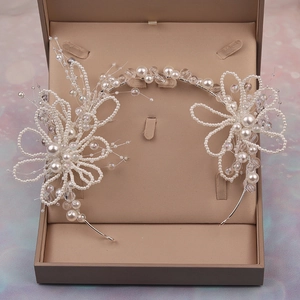 Elegant bridal headpiece with pearl floral design in a jewelry box for wedding styling