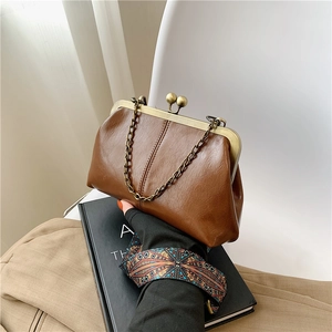 Vintage caramel brown shell bag with retro metal clasp and elegant chain strap for women