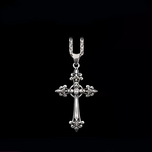 925 silver cross pendant necklace with skull detail and crystal on black background