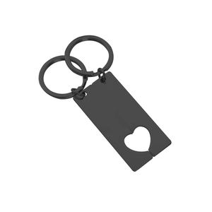Close-up of black stainless steel interlocking heart puzzle keychain for couples