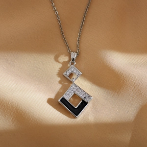 Geometric diamond-shaped pendant necklace with black enamel and white zircon inlay