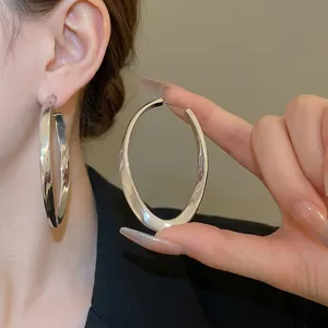 Exaggerated silver chunky oval hoop earrings with minimalist sculptural design for women