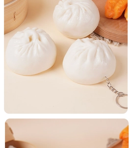 Detailed view of realistic PVC steamed bun keychain with metal ring on rustic background