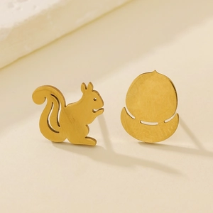 Asymmetric gold squirrel and acorn stud earrings on a clean minimalist cream background