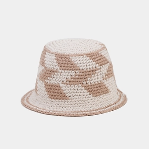 Detail of hollow diamond crochet knit bucket hat with beige checkerboard pattern texture