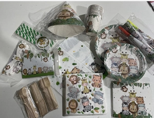 Flat lay of jungle animal party tableware set featuring lion and tiger cartoon patterns