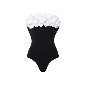 Detail of elegant black one-piece swimsuit featuring 3D white floral petals on the bust