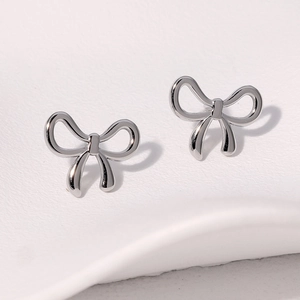 Elegant silver bow stud earrings in polished stainless steel on a white background