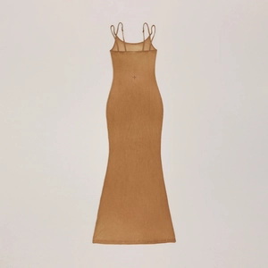 Detail of tan slim fit slip dress featuring adjustable straps and back embroidery detail
