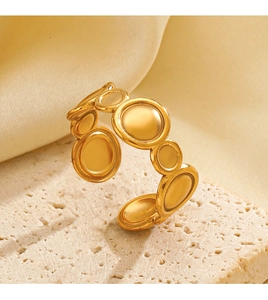 Detail of matte gold geometric ring on stone texture showing luxury metallic finish