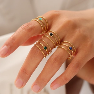 Close-up of 18K gold stainless steel rings set with natural semi-precious gemstones