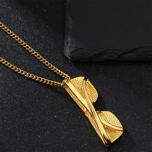 Creative gold sunglasses pendant necklace with metallic texture on dark stone background