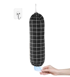 Detail of checkered fabric grocery bag organizer with hand extracting a plastic bag