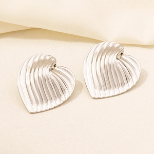 Detail of silver 304 stainless steel heart stud earrings with vertical ribbed texture