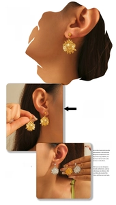 Detail view of sunflower drop earrings in gold and silver finish on model