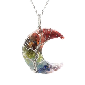 Detailed close-up of tree of life wire wrap on crescent moon natural crystal pendant