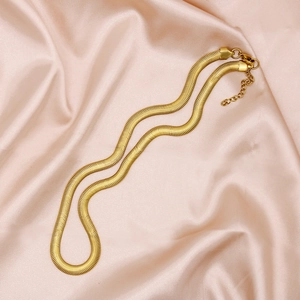 Elegant 6mm gold-plated flat snake chain necklace displayed on pink silk fabric