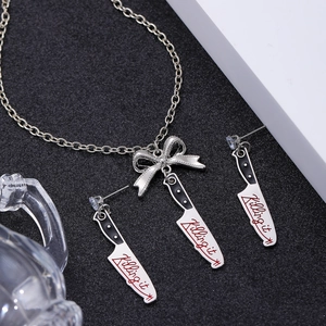 Punk style silver necklace and earrings set featuring 'Killing it' cleaver bow pendants