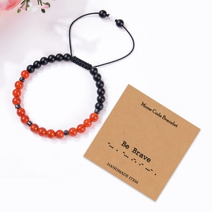 Morse Code Strength Bracelet featuring Red Agate beads and black woven cord on display card