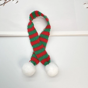 Detailed view of 30cm knit Christmas scarf with red green stripes and white pom-poms