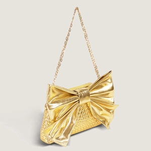Golden bow-shaped crossbody chain bag with woven texture and metallic finish for women
