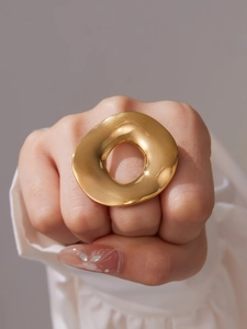 Macro shot of 18k gold plated stainless steel ring with organic irregular fluid texture