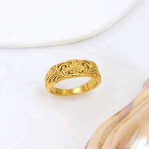 French style gold ring featuring intricate rose and vine relief patterns on a metal surface