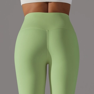 Detail view of high waist yoga leggings with butt-lifting seam in soft light green