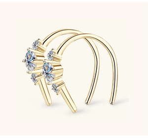 Macro detail of gold double-hoop ear cuff with multiple round-cut moissanite stones