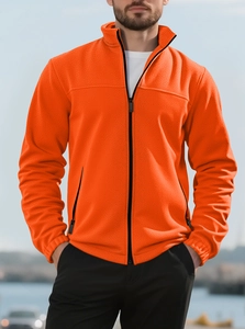 Macro view of orange heavy fleece jacket texture and sturdy stand collar with zip