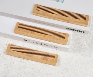 Detailed view of three eco-friendly bamboo fine-tooth combs on a minimalist white setting