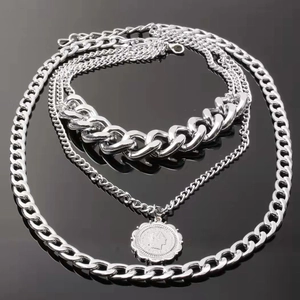 Multi-layer silver chain necklace with embossed coin pendant in heavy metal style