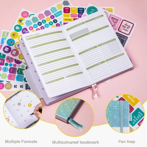 Detail view of monthly planner showing pen loop, colored bookmarks and inner page layouts
