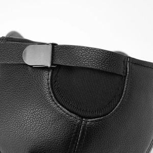 Close-up of black textured leather with silver metal buckle and ribbed knit detail