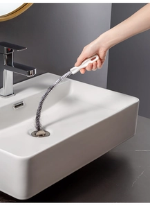 Manual flexible sink snake drain cleaner brush removing hair clogs from bathroom basin