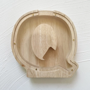 Detail of Q-shaped wooden money box with transparent acrylic cover and gold screws