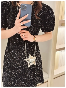 Close-up of a silver star-shaped metallic mini bag with a sleek chain strap