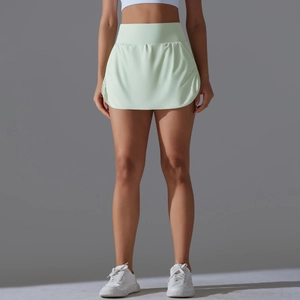 Detailed side view of high-waisted pale green tennis skort with hidden safety shorts