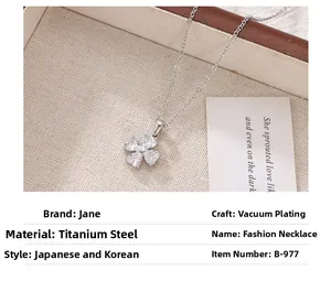 Detail of four-leaf clover pendant made of crystal hearts on a silver titanium steel chain