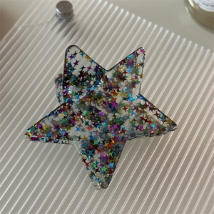Star-shaped hair claw clip in transparent acrylic with colorful sparkling sequins