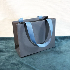 Gray-blue jewelry paper gift bag with sky blue ribbon handles and solid structure