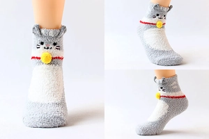 Three-way view of plush cat-themed coral fleece socks in grey and white with red collar