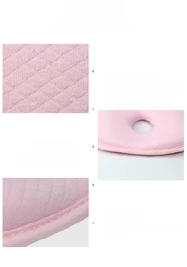 Detail of pink memory foam baby pillow showing breathable fabric texture and stitching