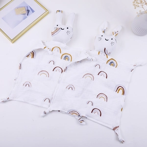 Close-up of two cotton gauze baby comforters with rainbow prints and cute rabbit heads